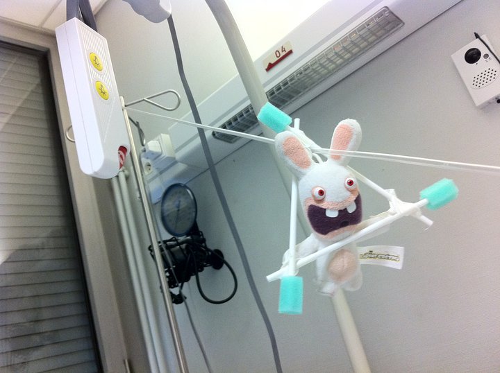 a rabbit stuffed animal hanging from a metal pole