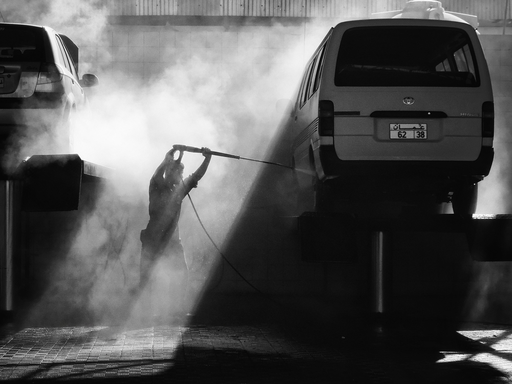 a person is on the side of the road holding onto a large rope