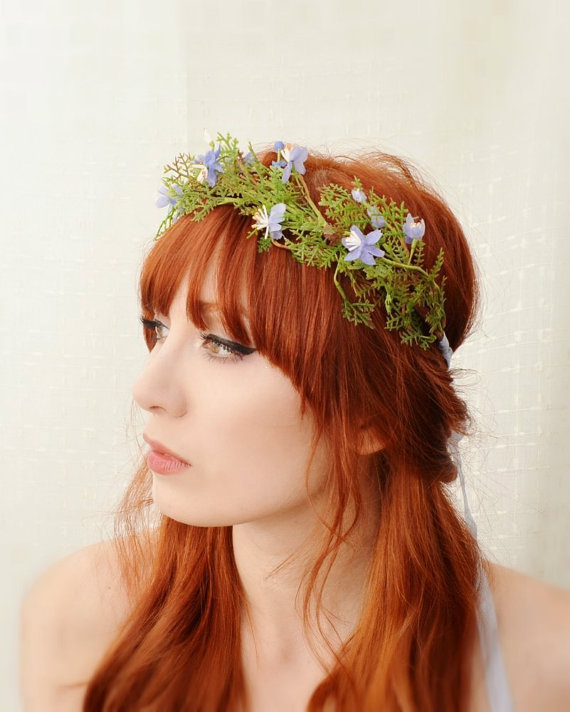 a red haired woman with flowers in her hair