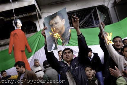 protesters in front of a painting of a politician