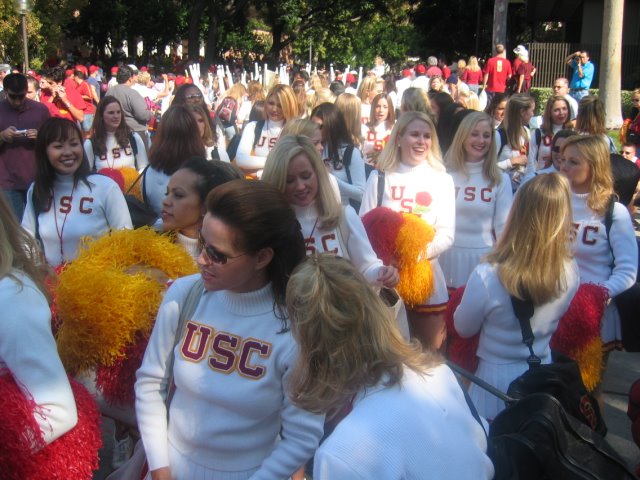 large group of women dressed in red and white cheerleader uniforms