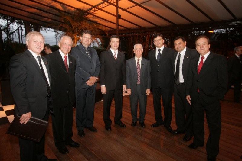 a group of men in business suits smiling together