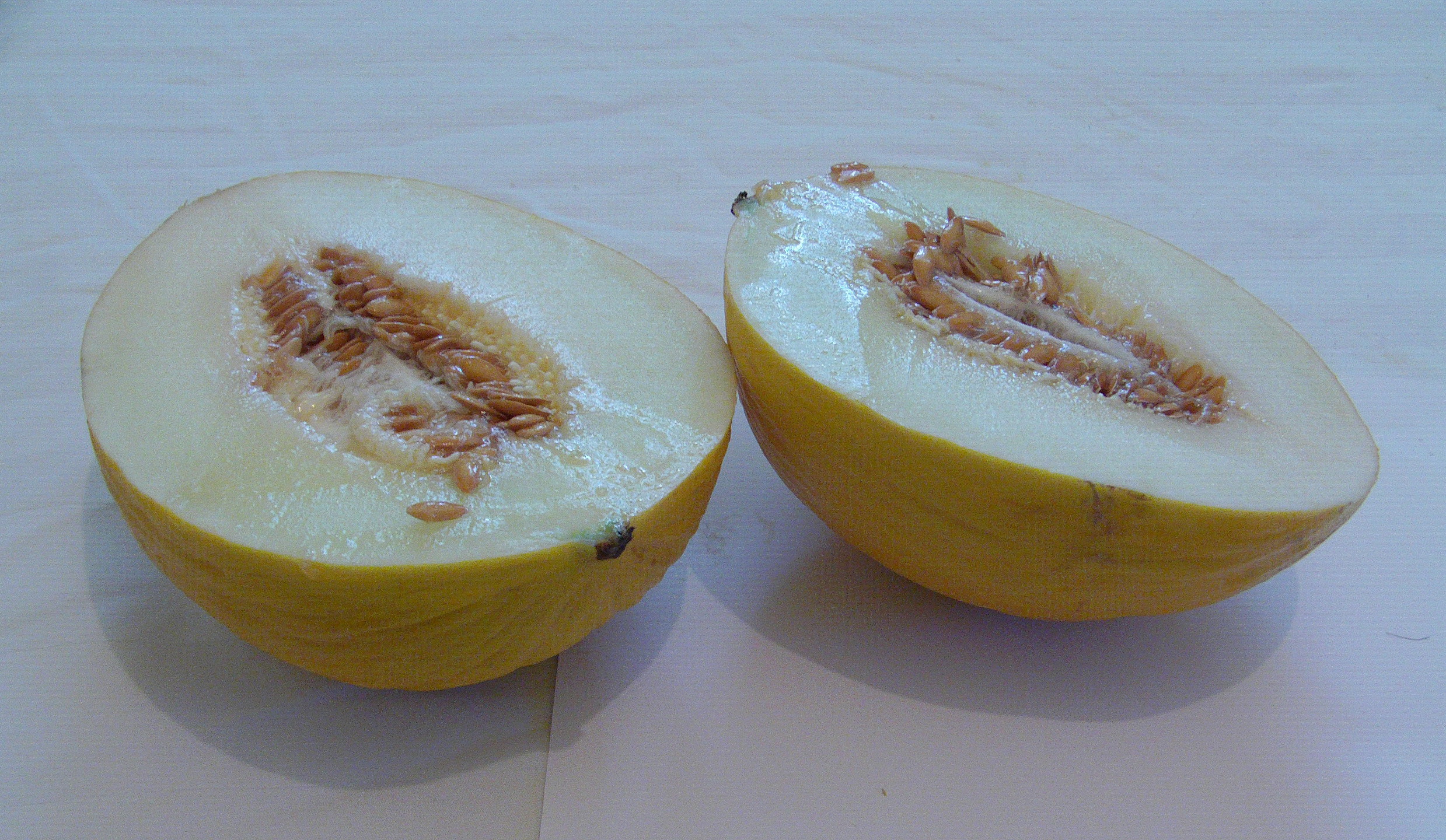 an orange sliced in half on a white table