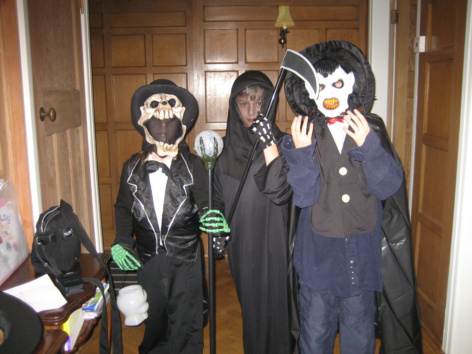 two young people wearing scary masks while holding bats