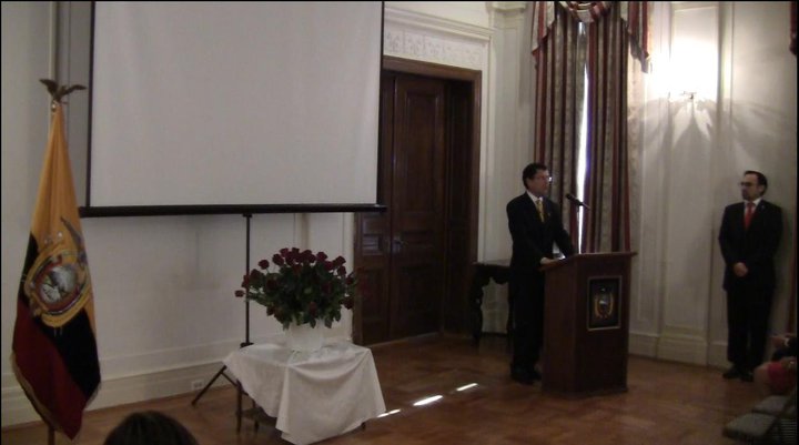 a man standing at a podium talking to an audience