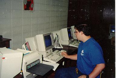 a man sitting in front of multiple monitors