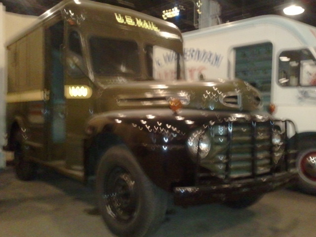 a brown and white bus in a parking garage