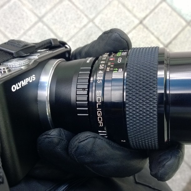 a camera is held up with its telepe lens