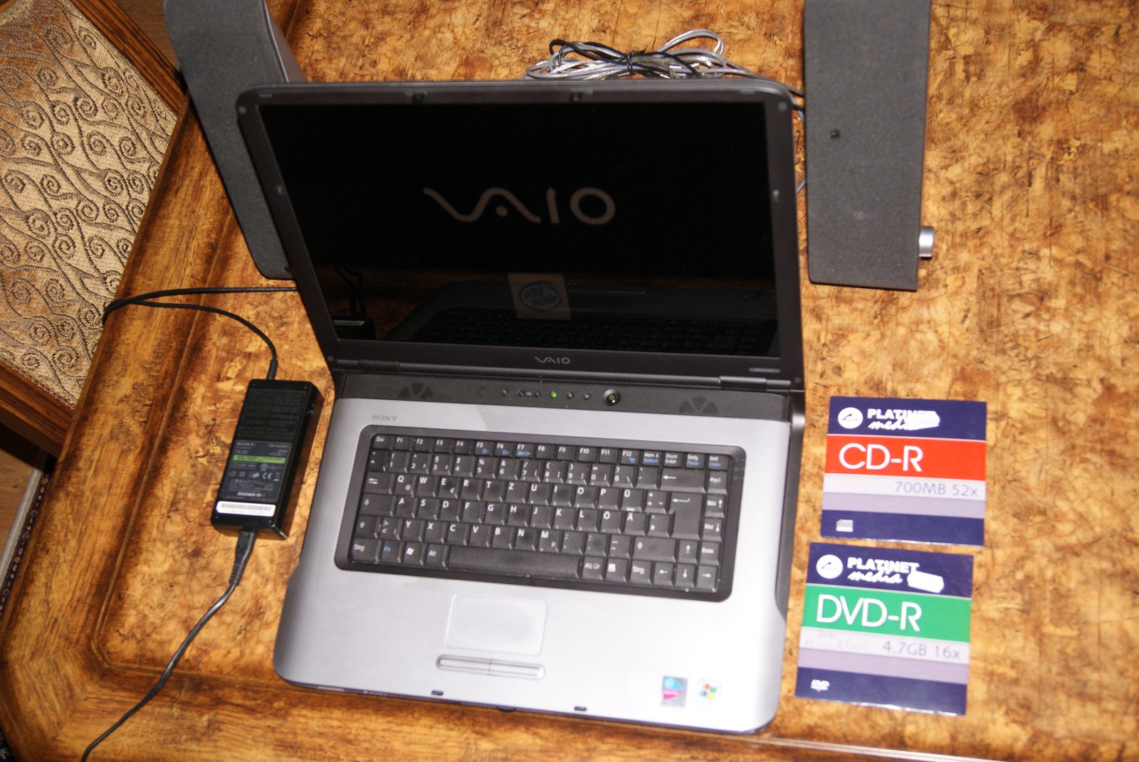 a small laptop computer sitting on top of a wooden desk