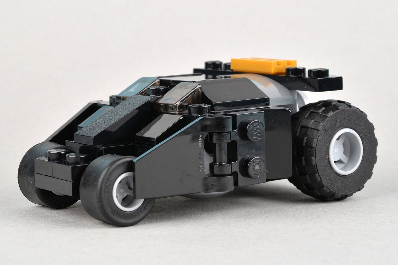 a lego batmobile with the front wheel missing