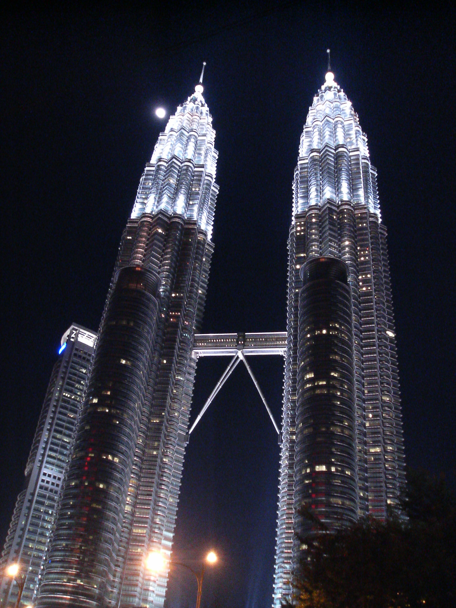 two large skyscrs that are lit up at night