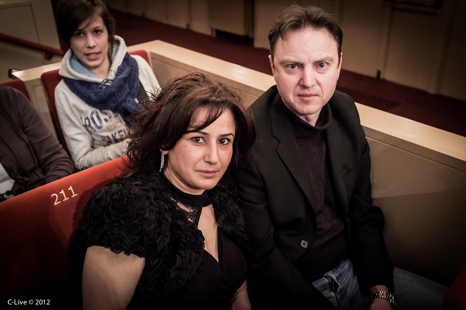 two people sitting down in a red chair