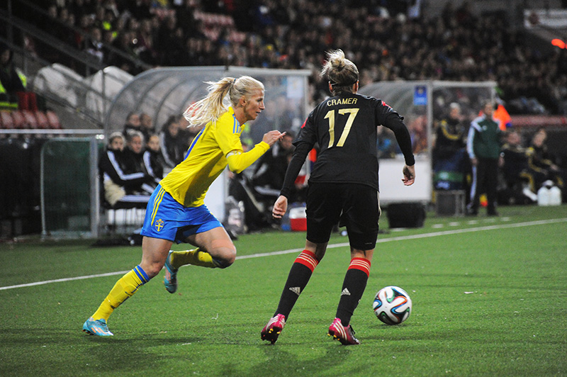 a female soccer player attempts to control the ball