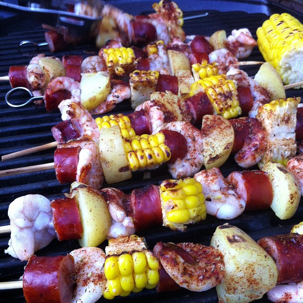 several different foods cooking on a grill