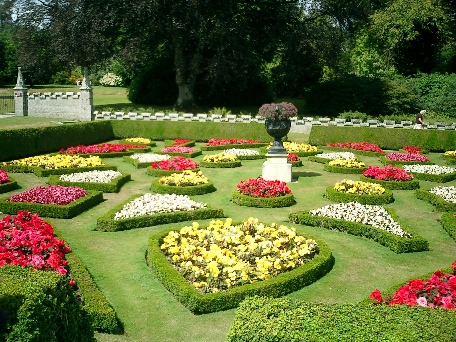 a large flower garden in the middle of some greenery