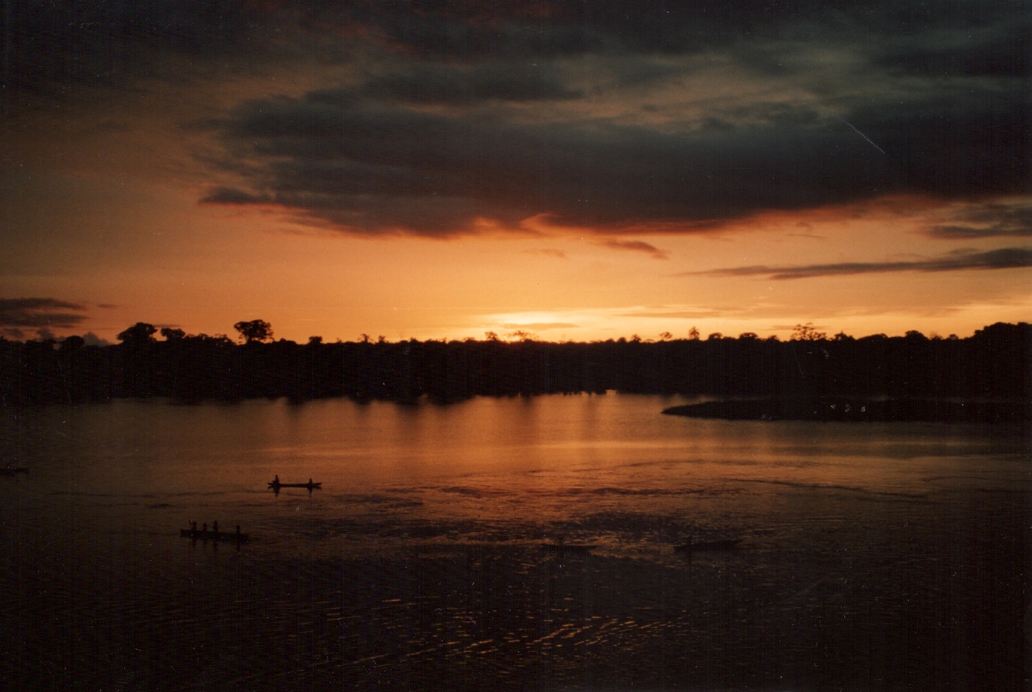 a sunset and some boats on the water