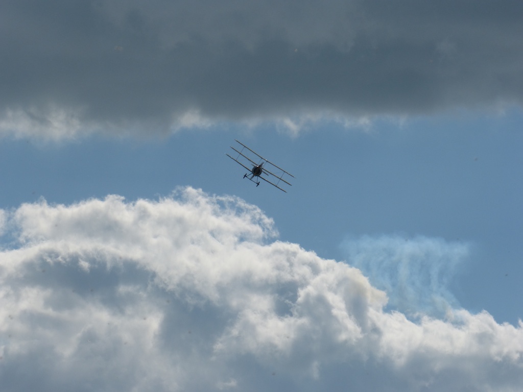 an airplane flying above the clouds in the sky