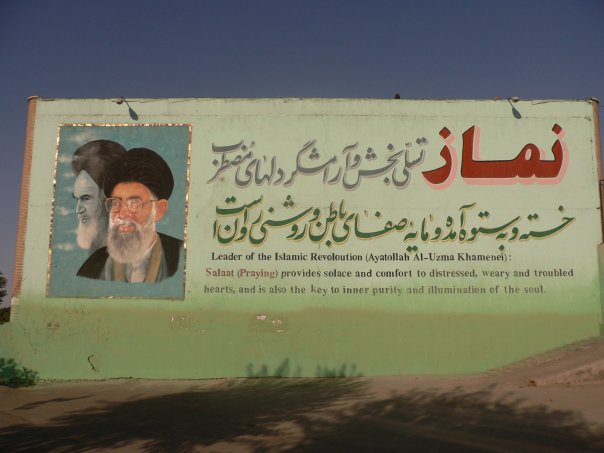 a large poster with an image of the great dictator in arabic and a tree