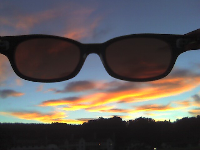 a pair of sunglasses that are in front of some clouds