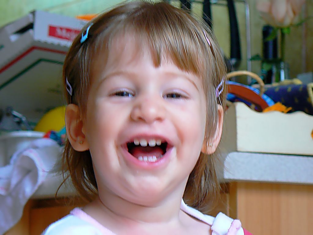 a child is laughing and making silly face