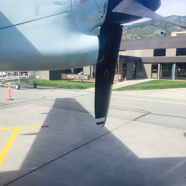 an airplane with propellers sitting on the runway