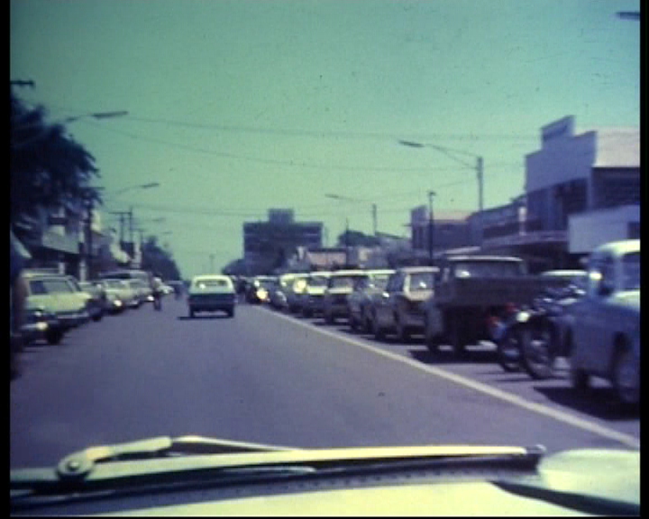 cars are traveling down a crowded street as it makes its way