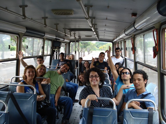 a group of people sitting on top of a bus