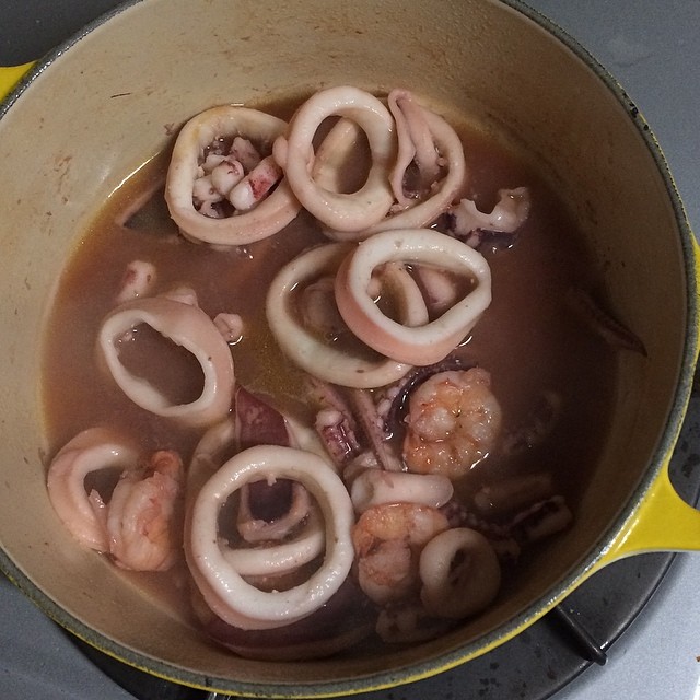 there are some squid rings and onions in the pot