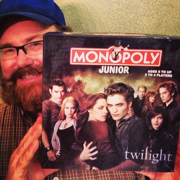 a man is holding up a vhs that features twilight