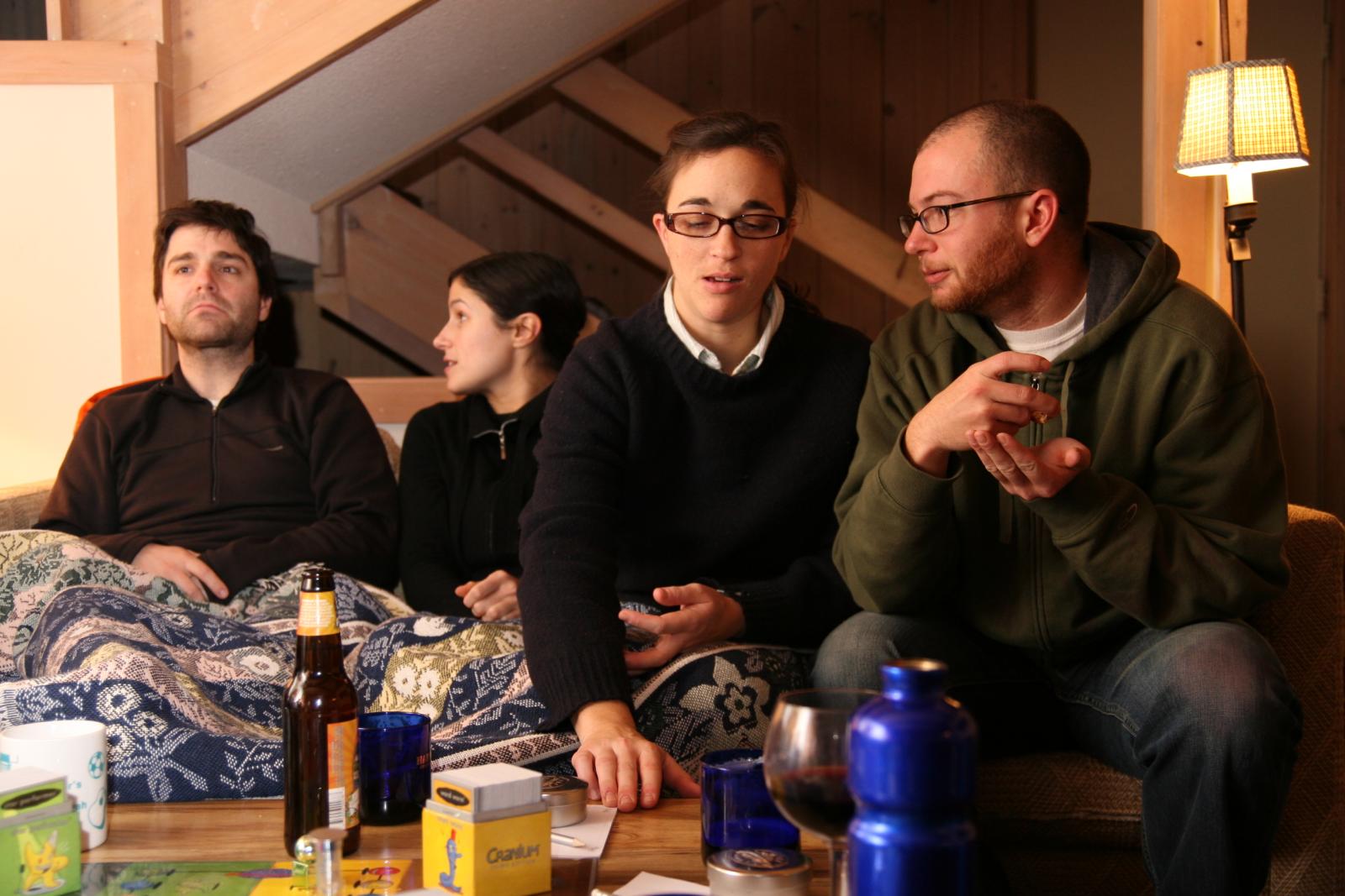 a group of people sit on a couch in front of a man