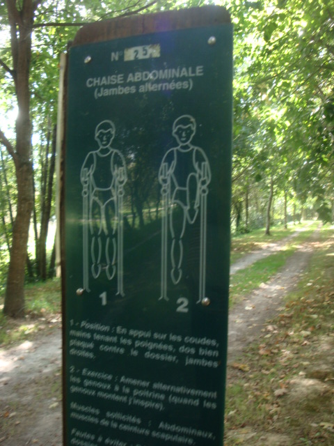 a sign for a couple walking along a dirt path