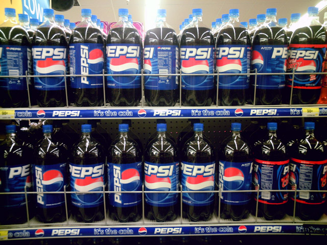 pepsi bottled water and soft drinks displayed on shelves