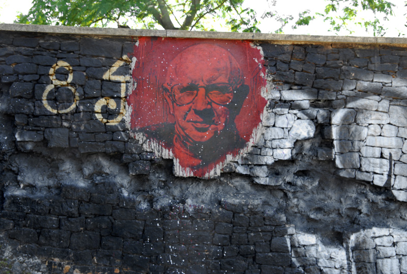 an older man is painted on a wall