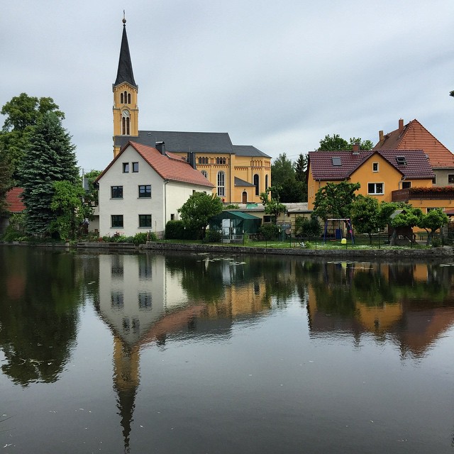 a reflection of a church on the water