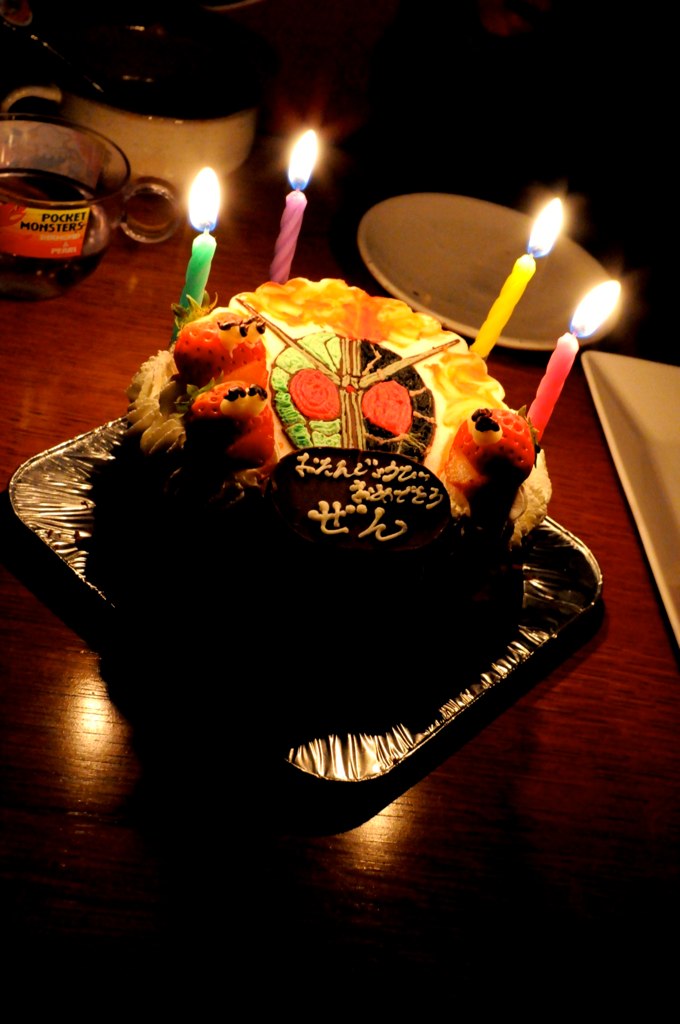 a birthday cake is covered in candles as seen from behind