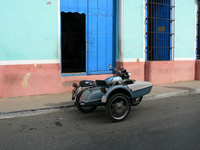 the motor cycle is parked on the side of the street