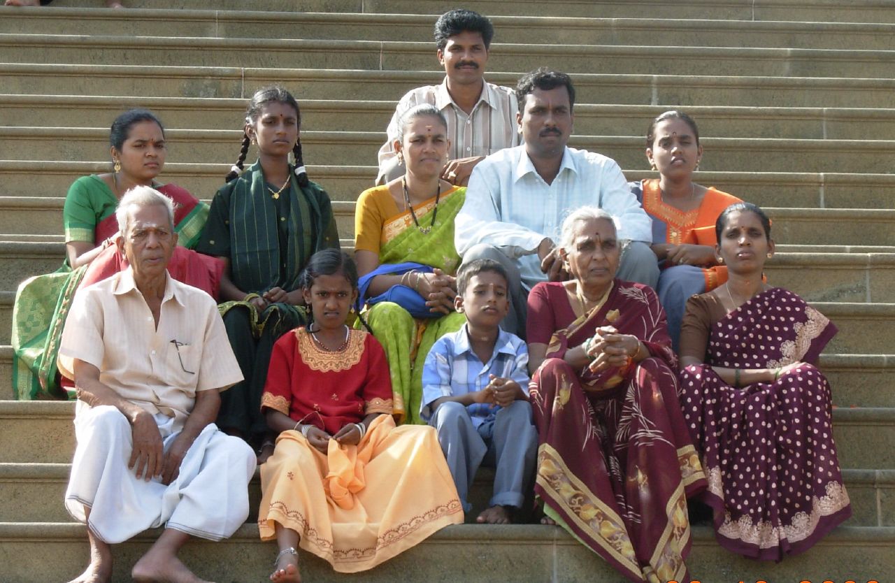 a group of indian people sitting on a stair case