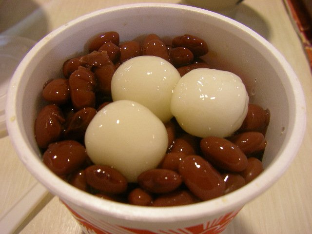 eggs are surrounded by chocolate in a paper cup