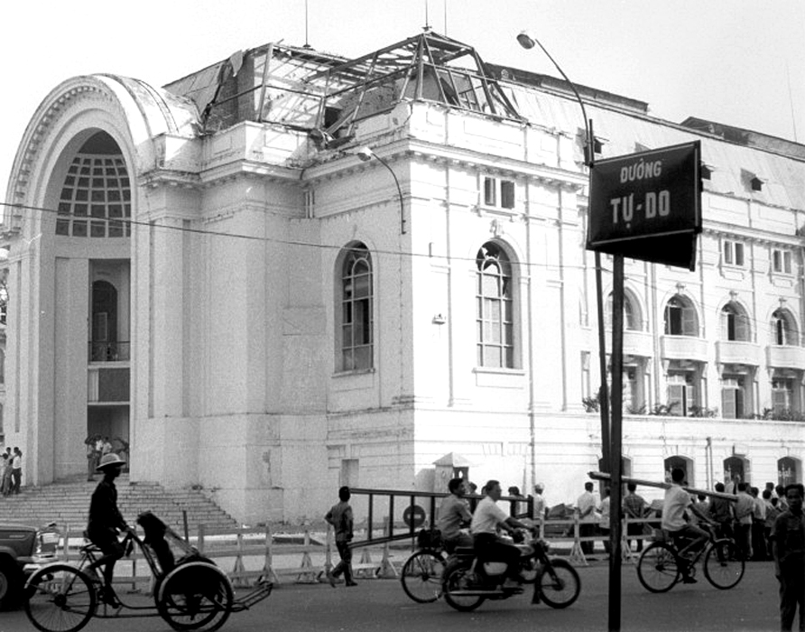 a few people on bikes and some are riding in front of an old building