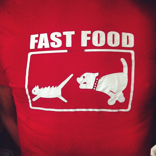 a person wearing a t - shirt with a design on it, that reads fast food