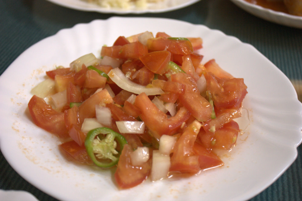 a white plate topped with tomatoes and onion slices