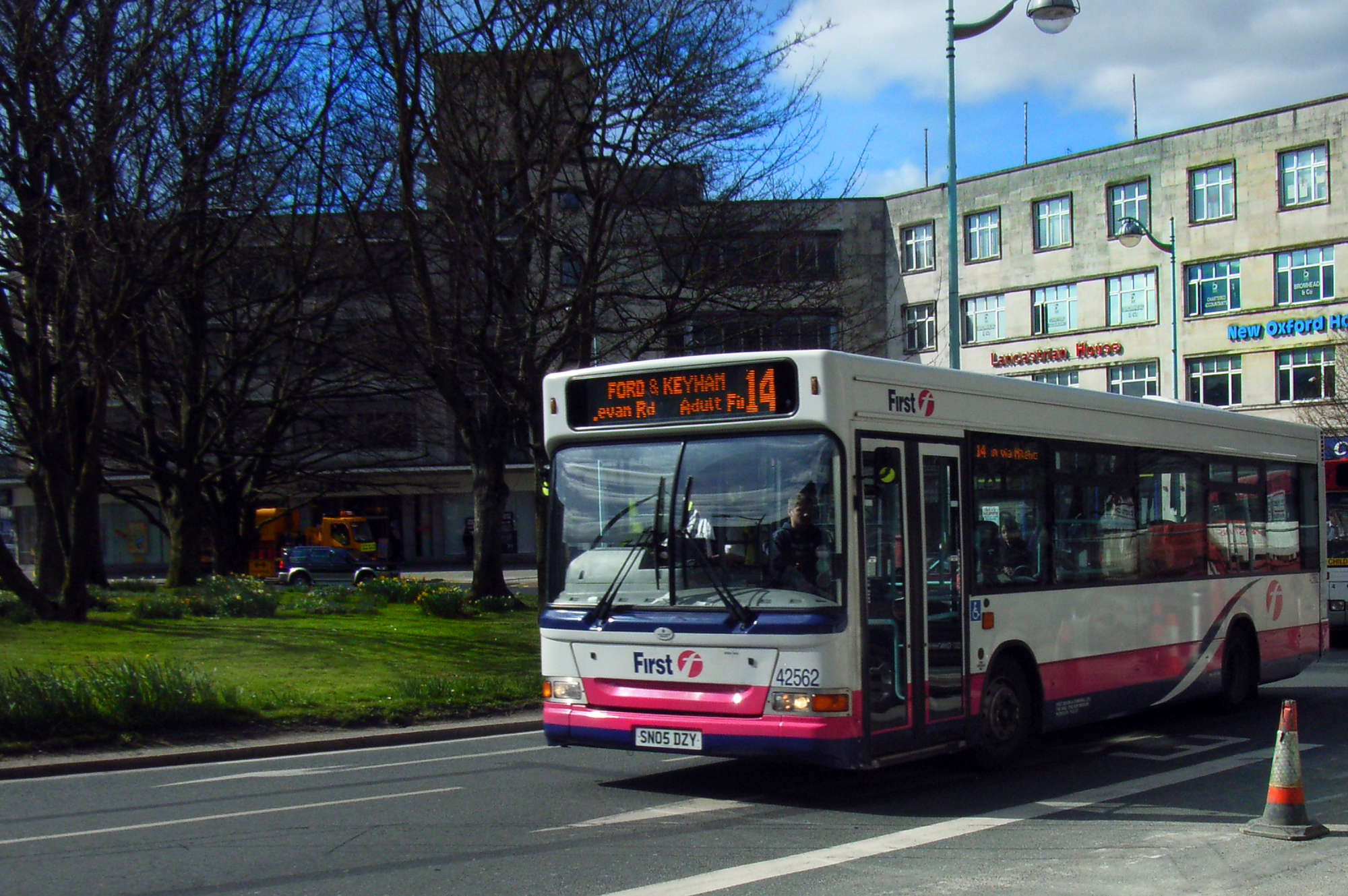 a passenger bus driving down the street