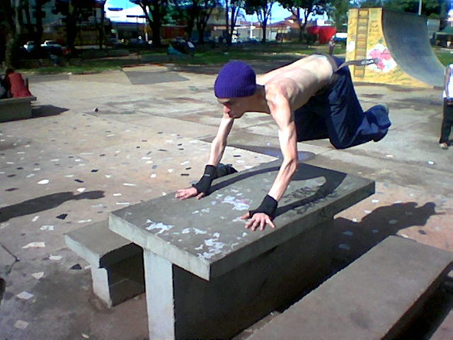a man performing an obstacle in a skate park