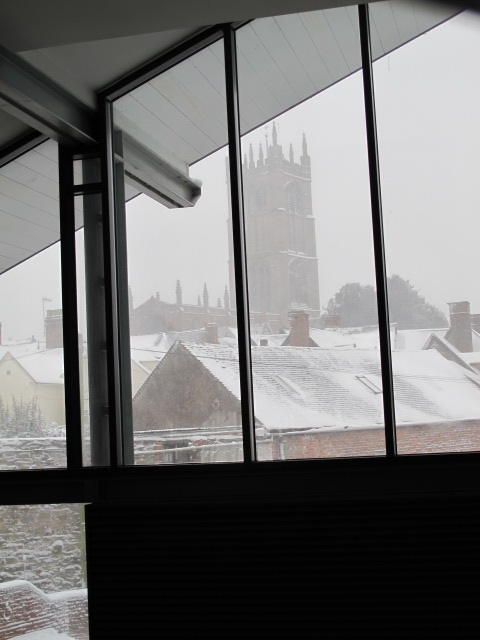 the view from inside a building looking at the snow