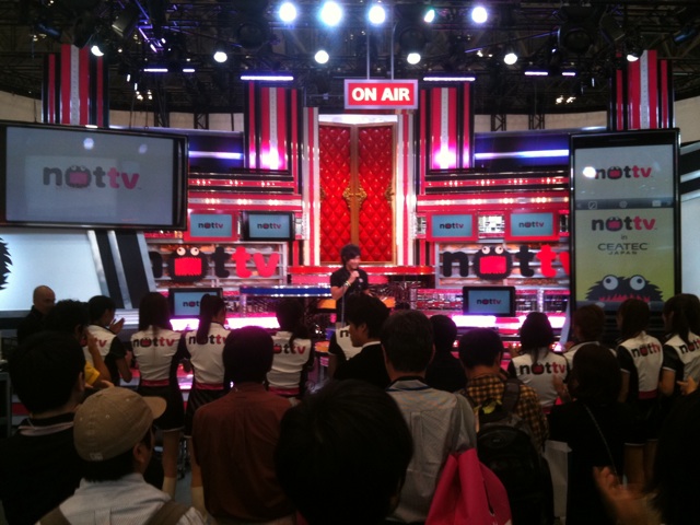 several people are standing in front of a tv studio
