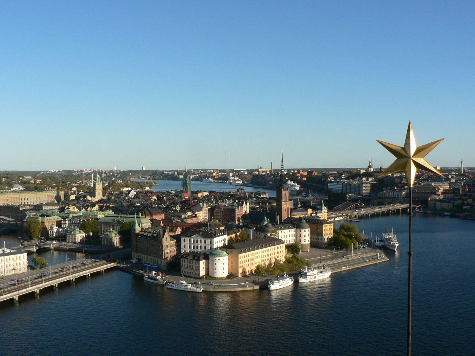 an aerial view of some buildings, water and boats