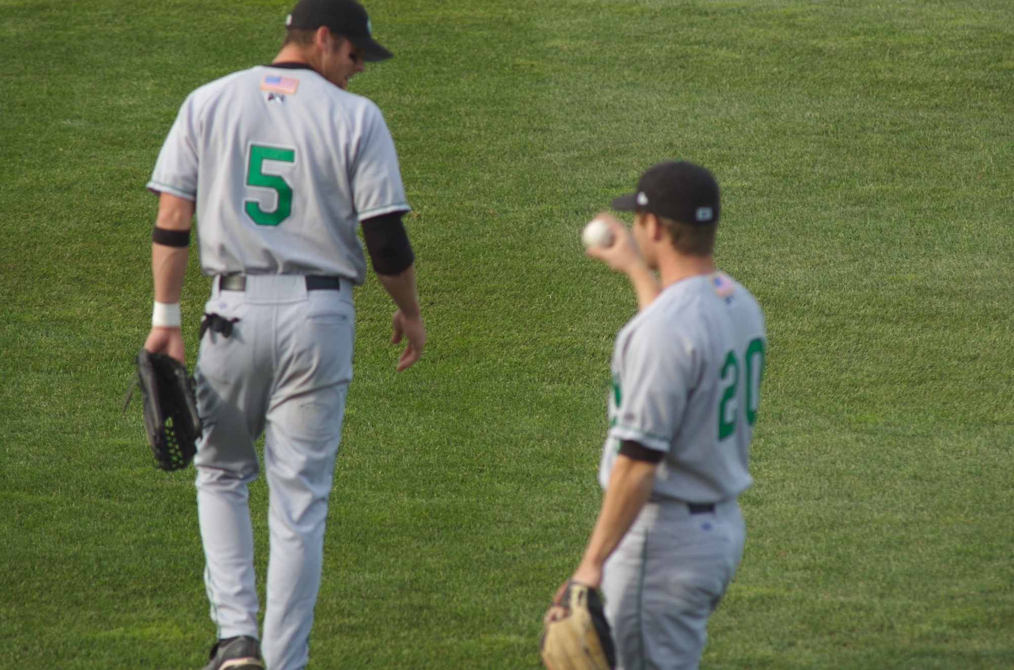two baseball players standing on a baseball field