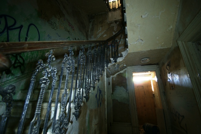 many items are laying on the stairs and in the house