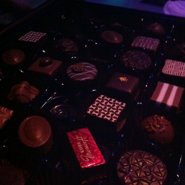 assorted chocolates in an elaborate tray arranged on a table