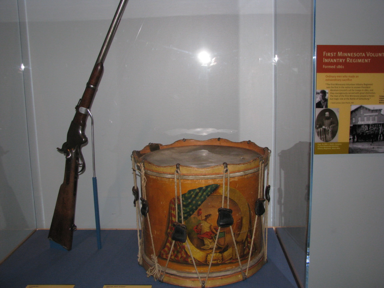 an old drum with the handle up is sitting on display